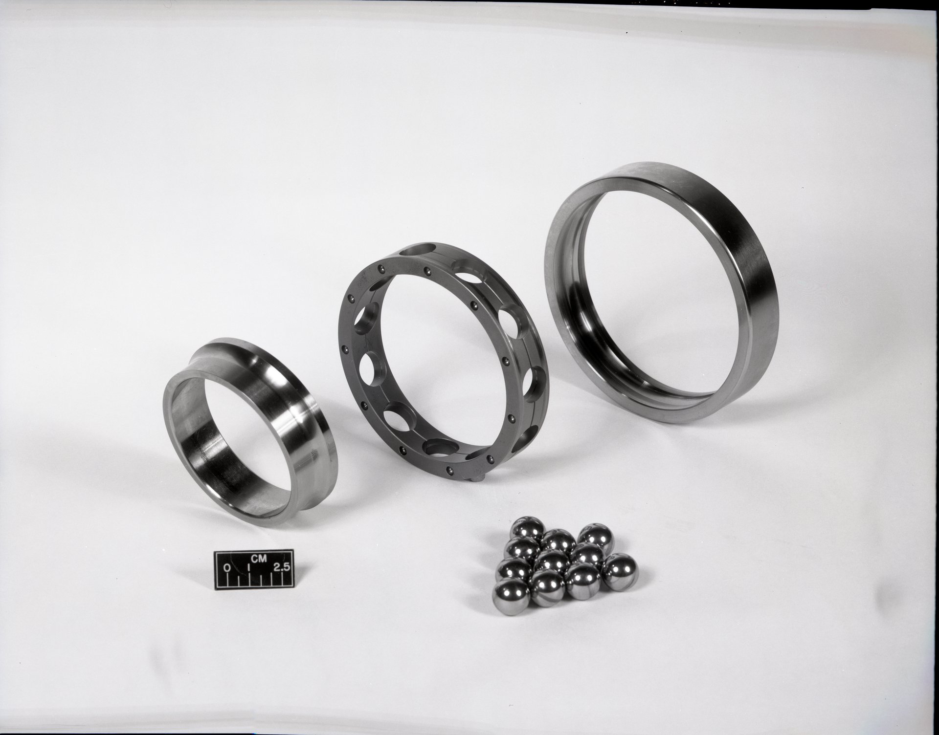Disassembled precision ball bearing showing inner ring, outer ring, and balls